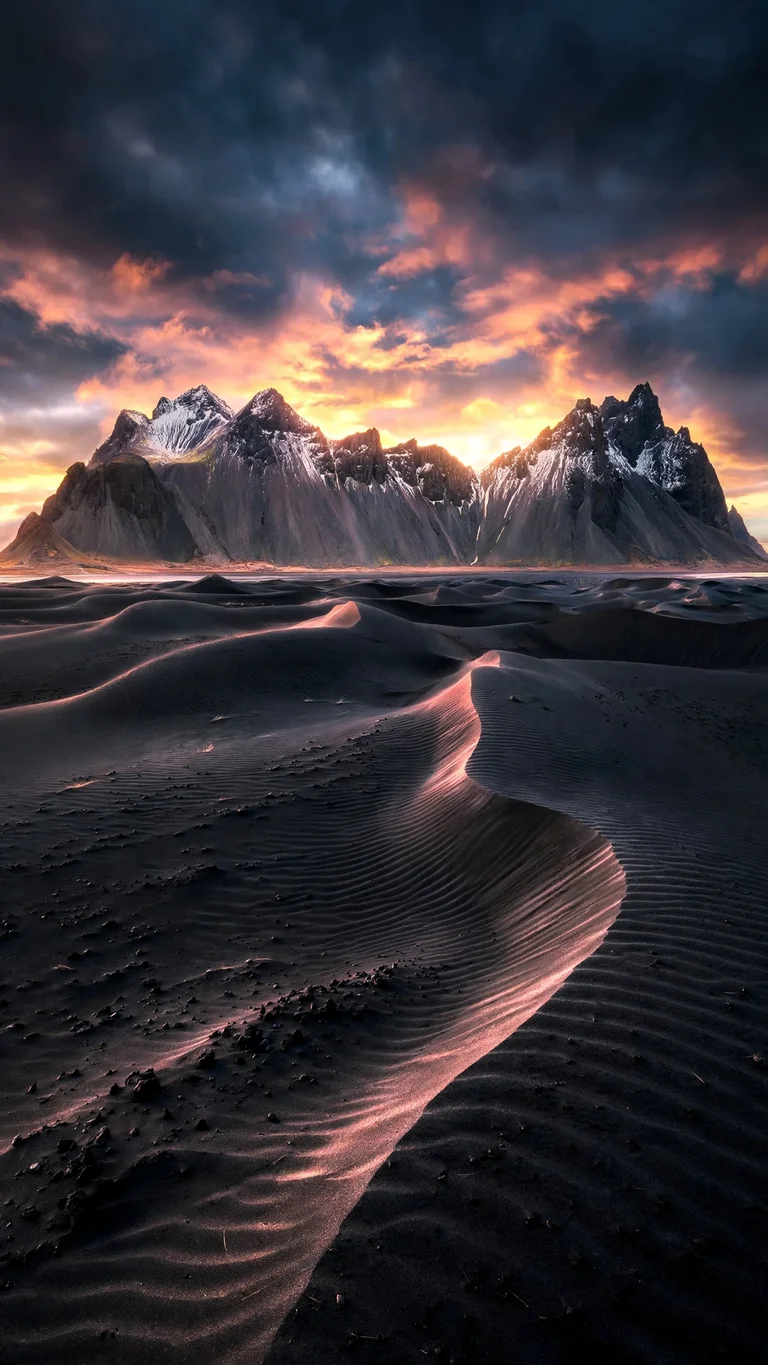 Vestrahorn peaks over black sand dunes at sunrise, vertical landscape wallpaper