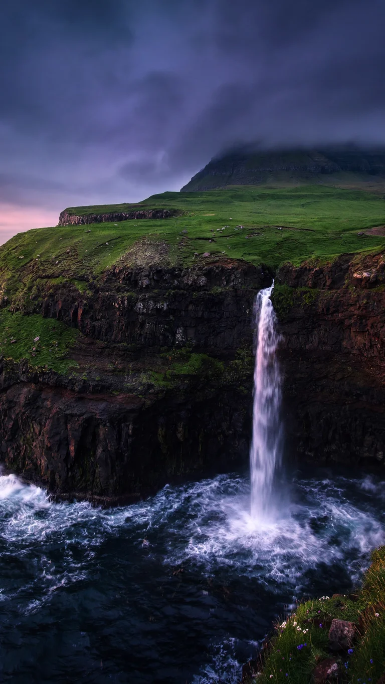 Mulafossur Waterfall Plunging to the Ocean phone wallpaper