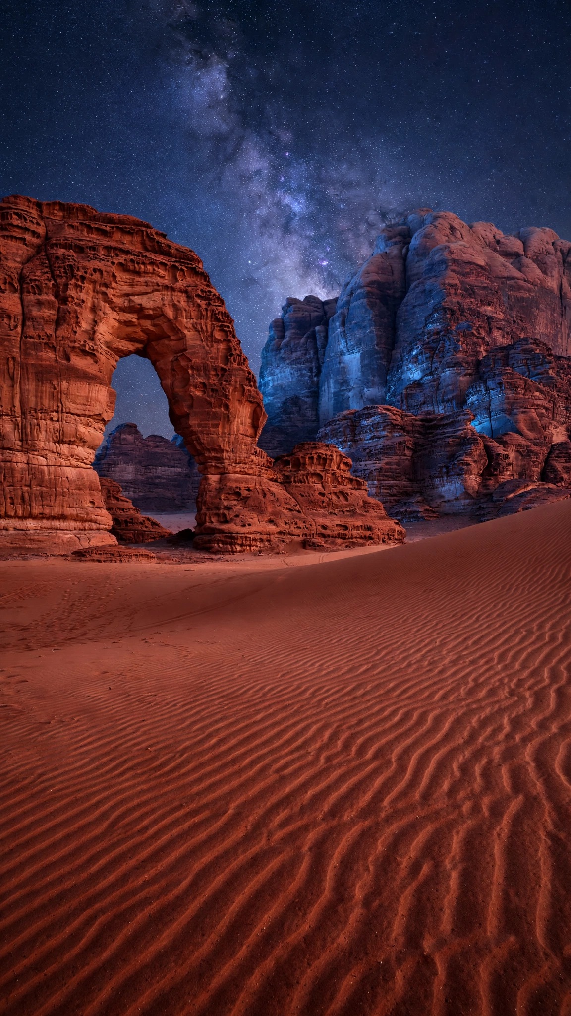 Wadi Rum sandstone arch under the Milky Way at night