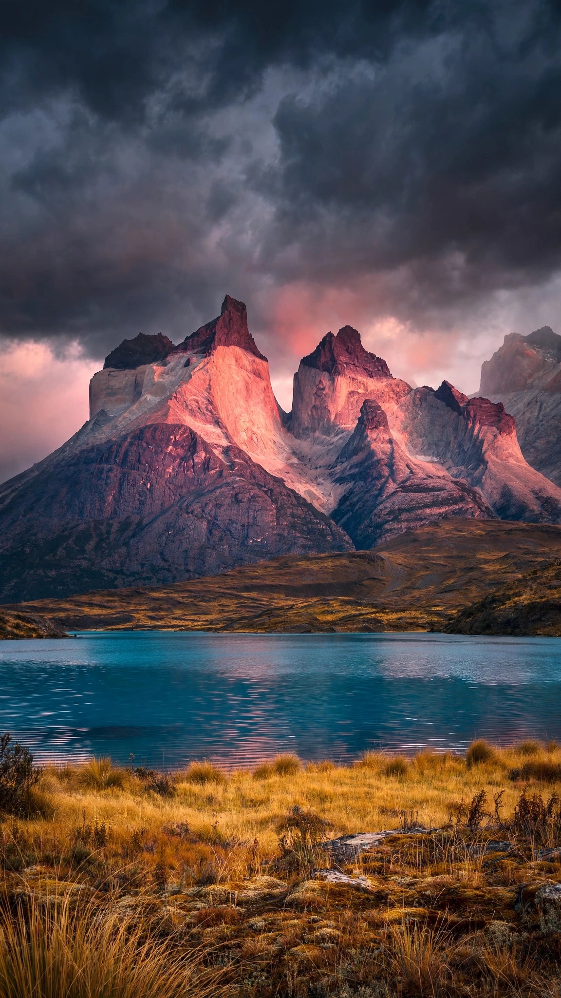 Patagonia granite towers glowing pink above a turquoise lake