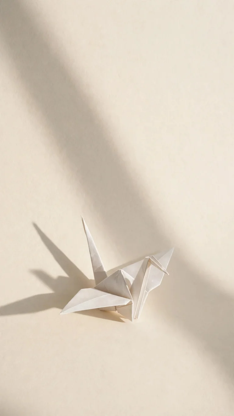Single white paper origami crane casting a soft long shadow on a cream background
