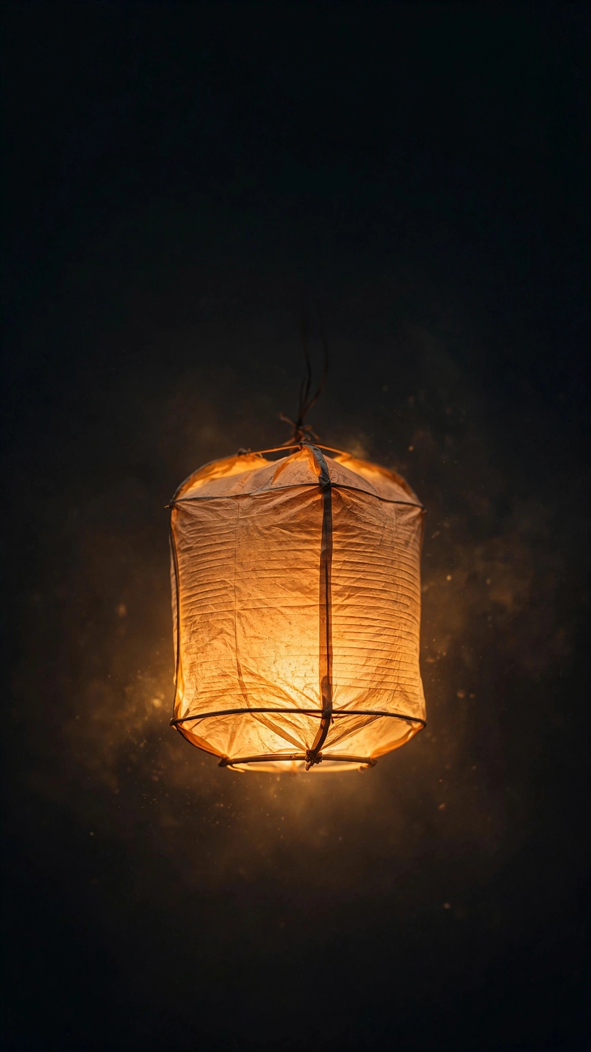 Glowing warm paper lantern in a dark gradient void