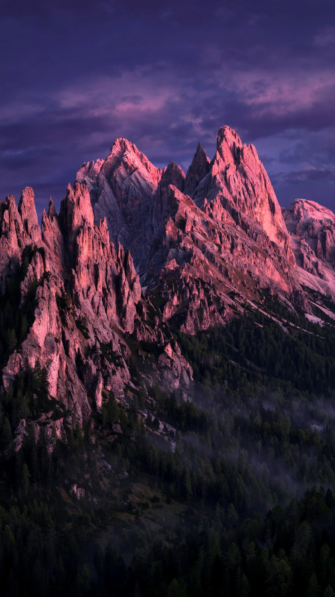 Dolomite mountain peaks glowing pink in evening alpenglow