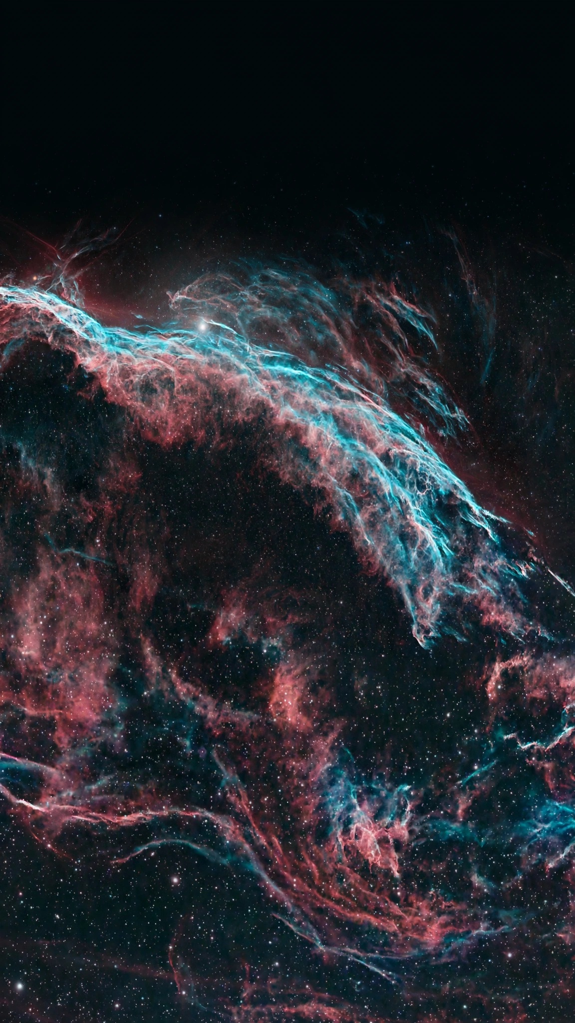 Glowing teal and rose filaments of the Veil Nebula