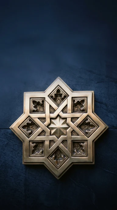 An islamic geometric star sculpted from polished brass.