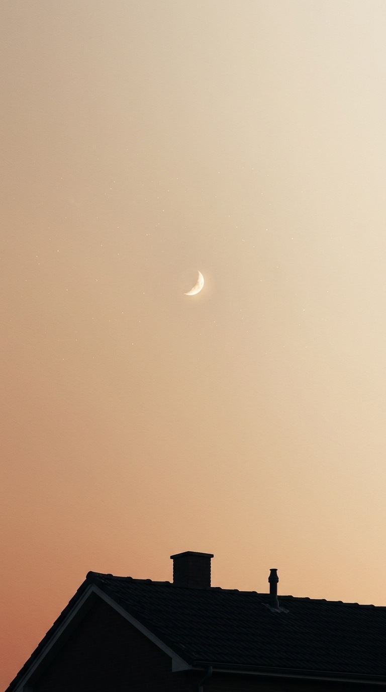 A small moon above a rooftop silhouette.