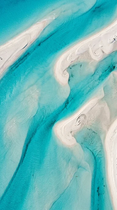 Aerial turquoise channels through sandbars.